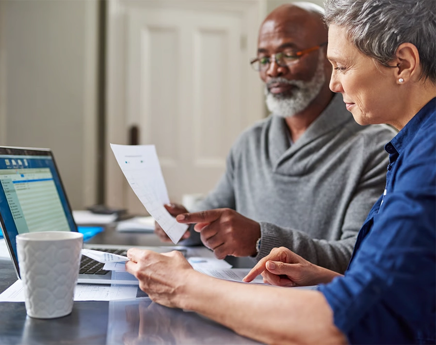 Two people reviewing retirement tax documents